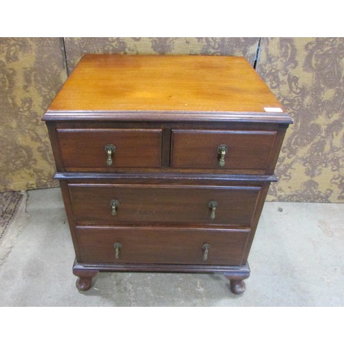 1226 - A small Edwardian mahogany chest of two long and two short drawers raised on squat cabriole supports... 