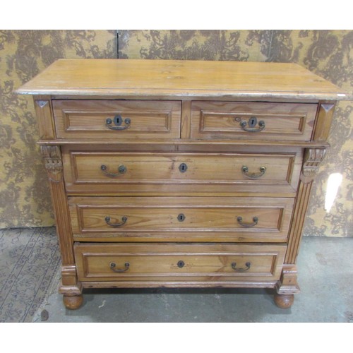 1227 - A 19th century continental stripped pine bedroom chest of three long and two short drawers flanked b... 