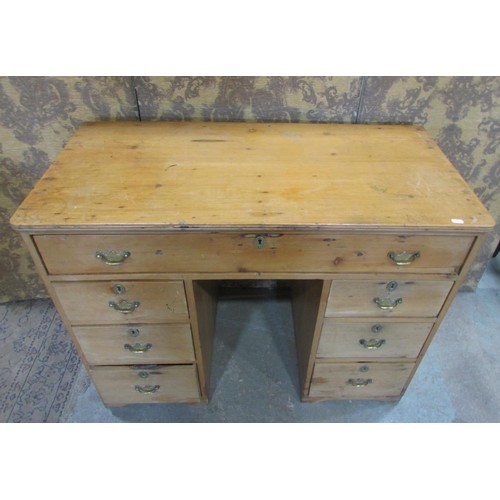 1229 - A 19th century stripped pine kneehole twin pedestal desk fitted with an arrangement of seven drawers... 