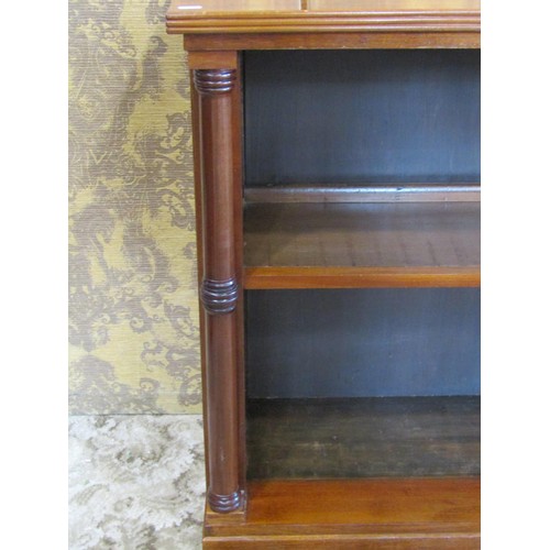 1237 - A dwarf floor standing open mahogany bookcase with turned columns flanking a fixed shelf, 80cm high ... 