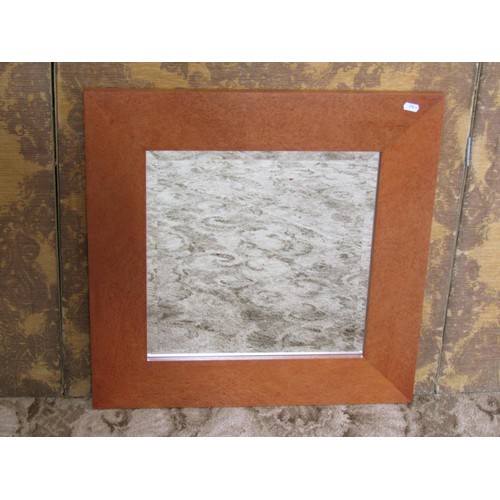 1242 - A contemporary John Coleman wall mirror with bevelled edge plate and burrwood frame labelled and dat... 