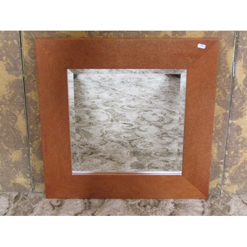 1242 - A contemporary John Coleman wall mirror with bevelled edge plate and burrwood frame labelled and dat... 