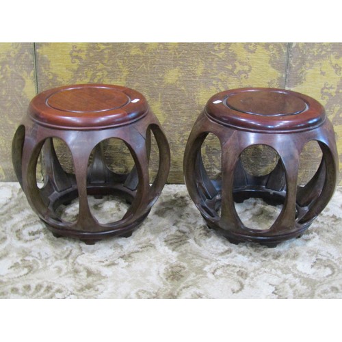 1243 - A pair of Chinese hardwood barrel shaped stools with open frames, 34cm high x 40cm diameter approx