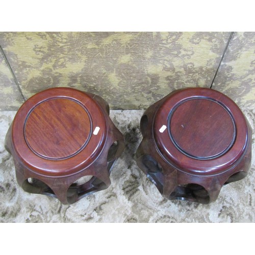 1243 - A pair of Chinese hardwood barrel shaped stools with open frames, 34cm high x 40cm diameter approx