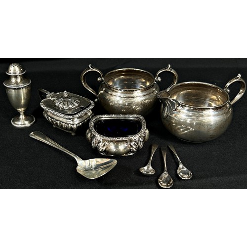 220 - A selection of silverware including a sugar bowl, milk jug, caddy spoon, pepper pot, condiments and ... 