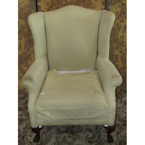 1253 - A reproduction Georgian style wing armchair raised on claw and ball supports