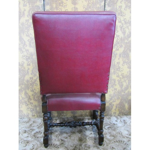 1254 - A carolean style open armchair with red faux leather upholstered seat and back within a carved frame... 