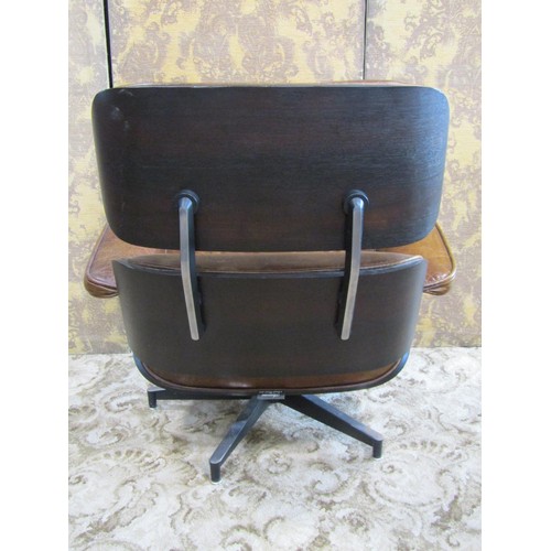 1257 - An Artsome Coach-house Collection 'Eames' style revolving chair and matching footstool with tan leat... 