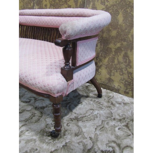 1258 - An Edwardian low backed parlour/bedroom sofa with repeating light pink ground upholstered seat, back... 