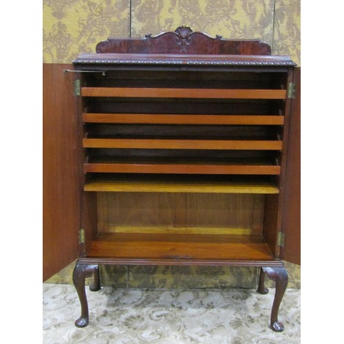 1264 - An Edwardian mahogany side cupboard with raised back rail over a pair of well matched flame veneered... 