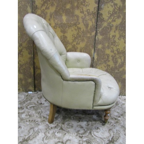 1265 - A Victorian style drawing room chair and matching footstool with buttoned cream leather upholstery