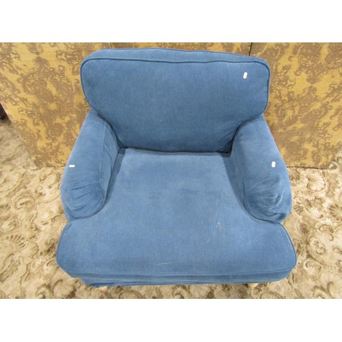 1269 - A substantial contemporary armchair with blue loose cushions and covers raised on beechwood supports... 