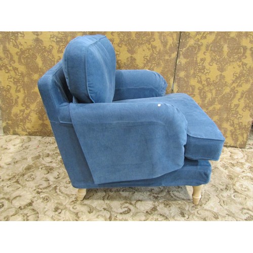 1269 - A substantial contemporary armchair with blue loose cushions and covers raised on beechwood supports... 