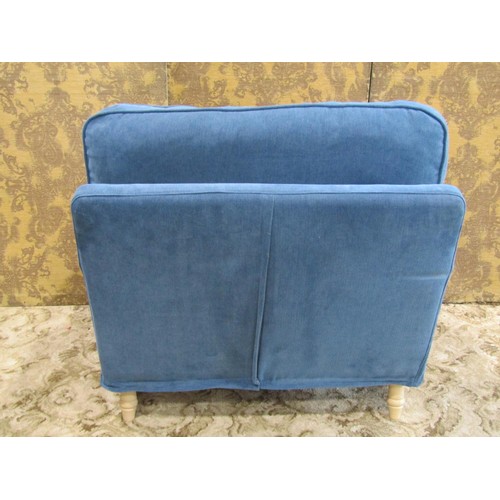 1269 - A substantial contemporary armchair with blue loose cushions and covers raised on beechwood supports... 