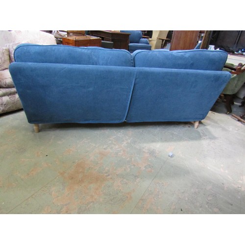 1270 - A substantial contemporary sofa with blue loose cushions and covers raised on beech wood supports, 8... 