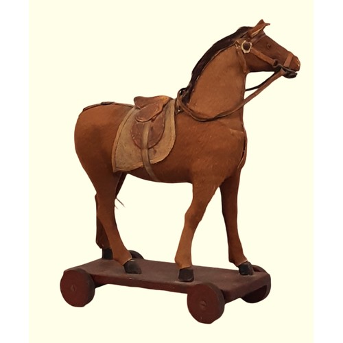 645 - Small antique toy horse, well modelled in wood and covered in pony skin, with leather bridle and sad... 