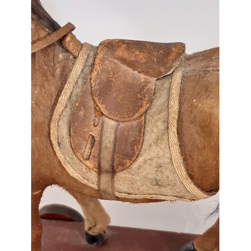 645 - Small antique toy horse, well modelled in wood and covered in pony skin, with leather bridle and sad... 