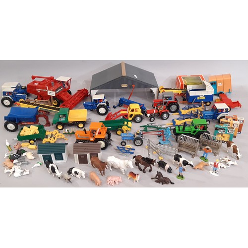 665 - A large collection Britains Farm models including 2 large buildings, a combine harvester, tractors, ... 