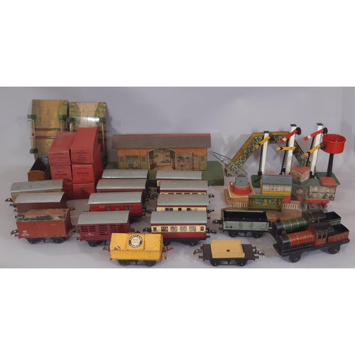 667 - A collection of Hornby 0 gauge rail models including coaches, buildings, lineside accessories, boxed... 