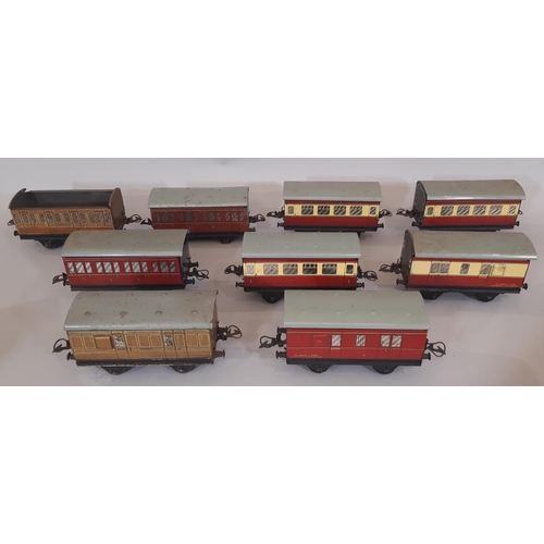 667 - A collection of Hornby 0 gauge rail models including coaches, buildings, lineside accessories, boxed... 