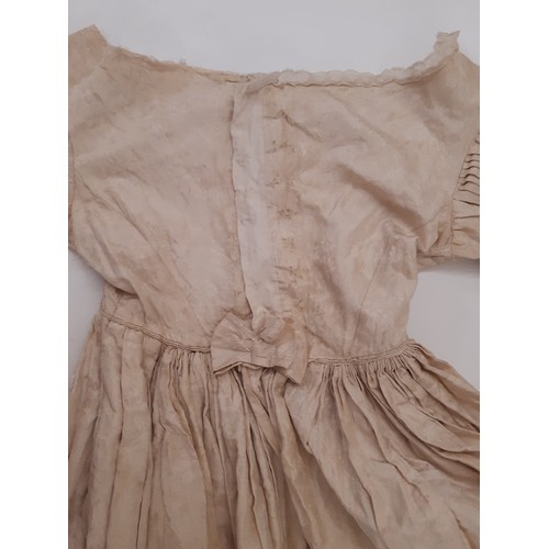 679 - Three late 19th /early 20th century garments comprising the following; a dress in ivory jacquard sil... 