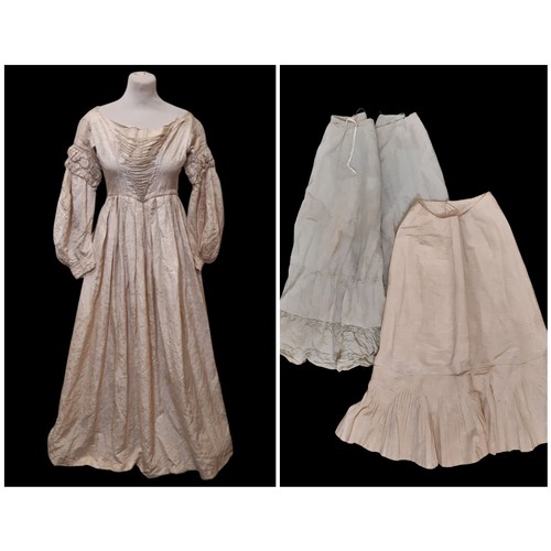 679 - Three late 19th /early 20th century garments comprising the following; a dress in ivory jacquard sil... 