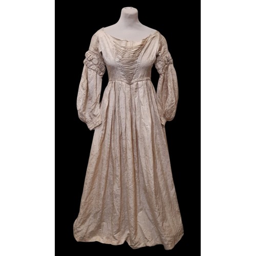 679 - Three late 19th /early 20th century garments comprising the following; a dress in ivory jacquard sil... 