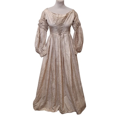 679 - Three late 19th /early 20th century garments comprising the following; a dress in ivory jacquard sil... 