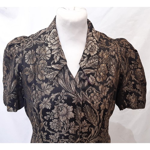 682 - 1930's short sleeved tailored jacket in black and gold fabric with a woven floral pattern and hook a... 