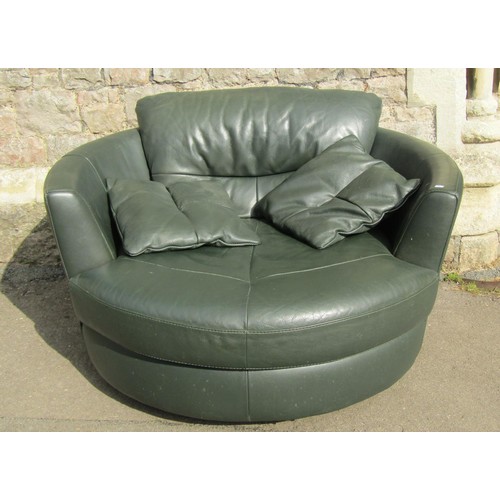 1272 - A substantial contemporary stitched green leather upholstered swivel lounge chair, 80cm high x 130cm... 