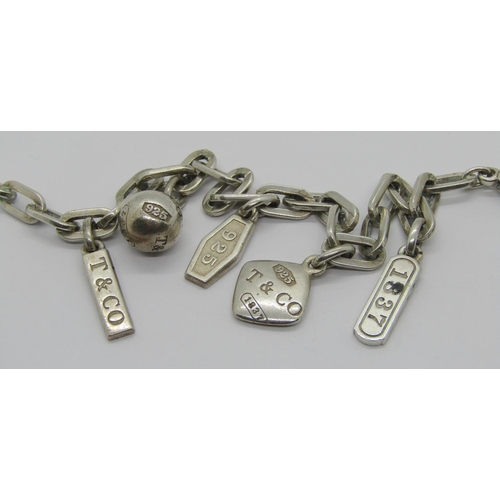 266 - Tiffany & Co. silver charm bracelet with five charms, stamped 'Italy 1980 MI', 28.5g