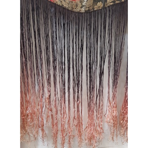 685 - An Art Deco lamé fringed evening shawl woven with large flowers on a black ground, with ombre dyed t... 