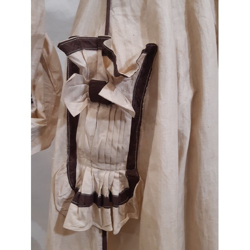 687 - Edwardian ladies dress in a dark cream cotton with contrasting brown piping and trim. Dress has fron... 