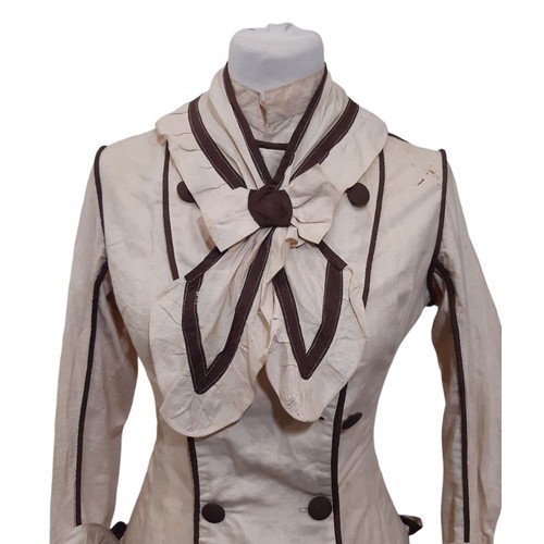 687 - Edwardian ladies dress in a dark cream cotton with contrasting brown piping and trim. Dress has fron... 