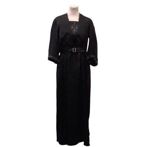 688 - Circa 1920 black silk dress with decorative  beaded detail to front panel and cuffs and lace trim at... 