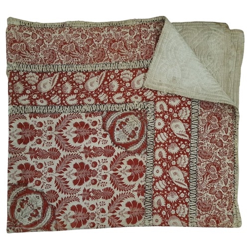 692 - Three vintage quilts including a reversible quilt of printed cotton quilted by hand with running sti... 