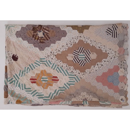 696 - A large vintage patchwork  panel/ quilt composed of hexagon patches of various printed cottons formi... 