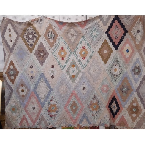 696 - A large vintage patchwork  panel/ quilt composed of hexagon patches of various printed cottons formi... 