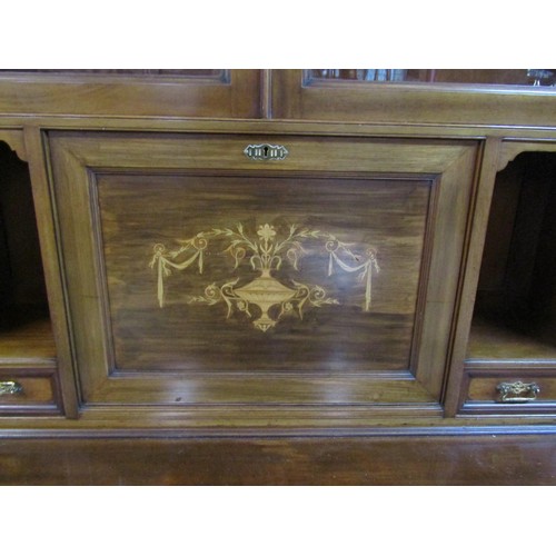 1281 - An unusual inlaid Edwardian secretaire bookcase enclosed by an arrangement of cupboards and drawers,... 