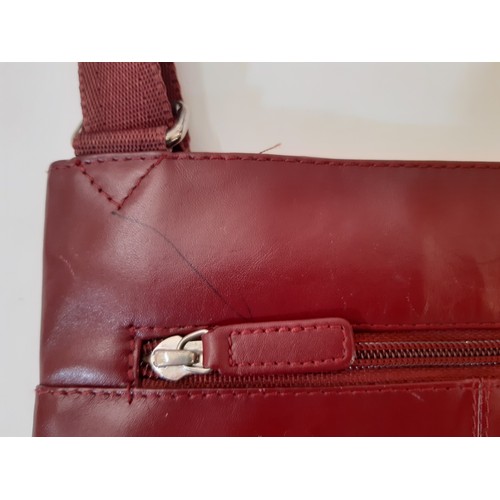 700 - Pockets handbag by Radley, in dark red leather, medium size (22x26cm) with zip closure, together wit... 