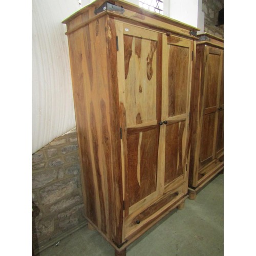 1283 - An Indian hardwood wardrobe enclosed by a pair of panelled doors over a long drawer, 180cm high x 10... 