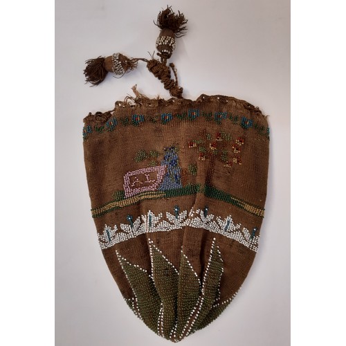 704 - A 19th century Native American beaded purse 17x16cm together with a leather lined beaded drawstring ... 