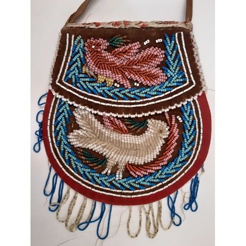 704 - A 19th century Native American beaded purse 17x16cm together with a leather lined beaded drawstring ... 