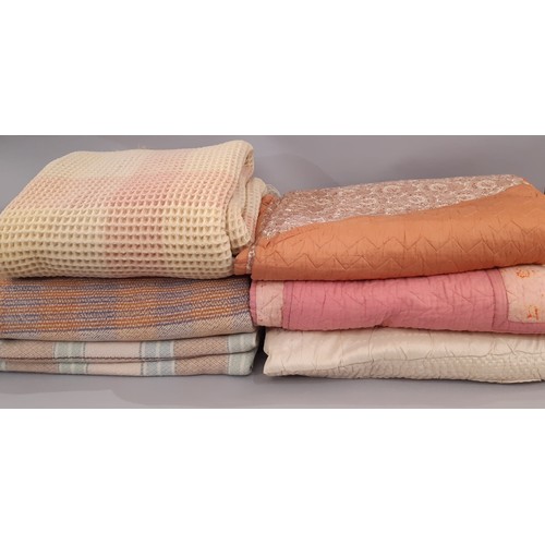 710 - Vintage quilts and blankets including a machine stitched quilt with contrasting panels of terracotta... 