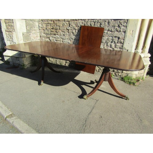 1301 - A Georgian mahogany twin pedestal D end dining table with two additional leaves raised on turned pil... 