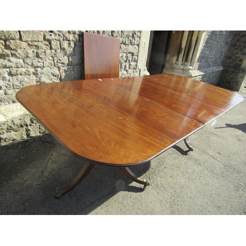 1301 - A Georgian mahogany twin pedestal D end dining table with two additional leaves raised on turned pil... 