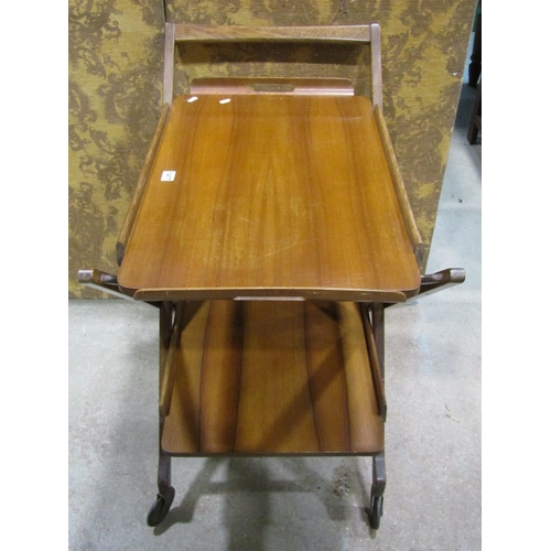 1302 - A mid 20th century walnut and stained beechwood two tier tea trolley with shaped tray top