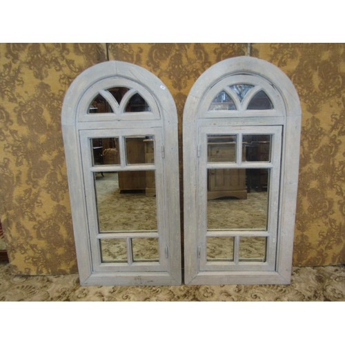 1310 - A pair of reclaimed pine arched window frames adapted as wall mirrors, with rustic pale blue painted... 