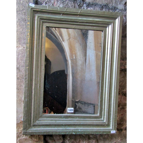 1312 - An Indian white metal clad wall mirror of stepped rectangular form, 65 x 49cm.