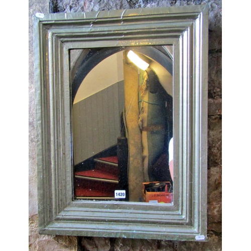 1312 - An Indian white metal clad wall mirror of stepped rectangular form, 65 x 49cm.